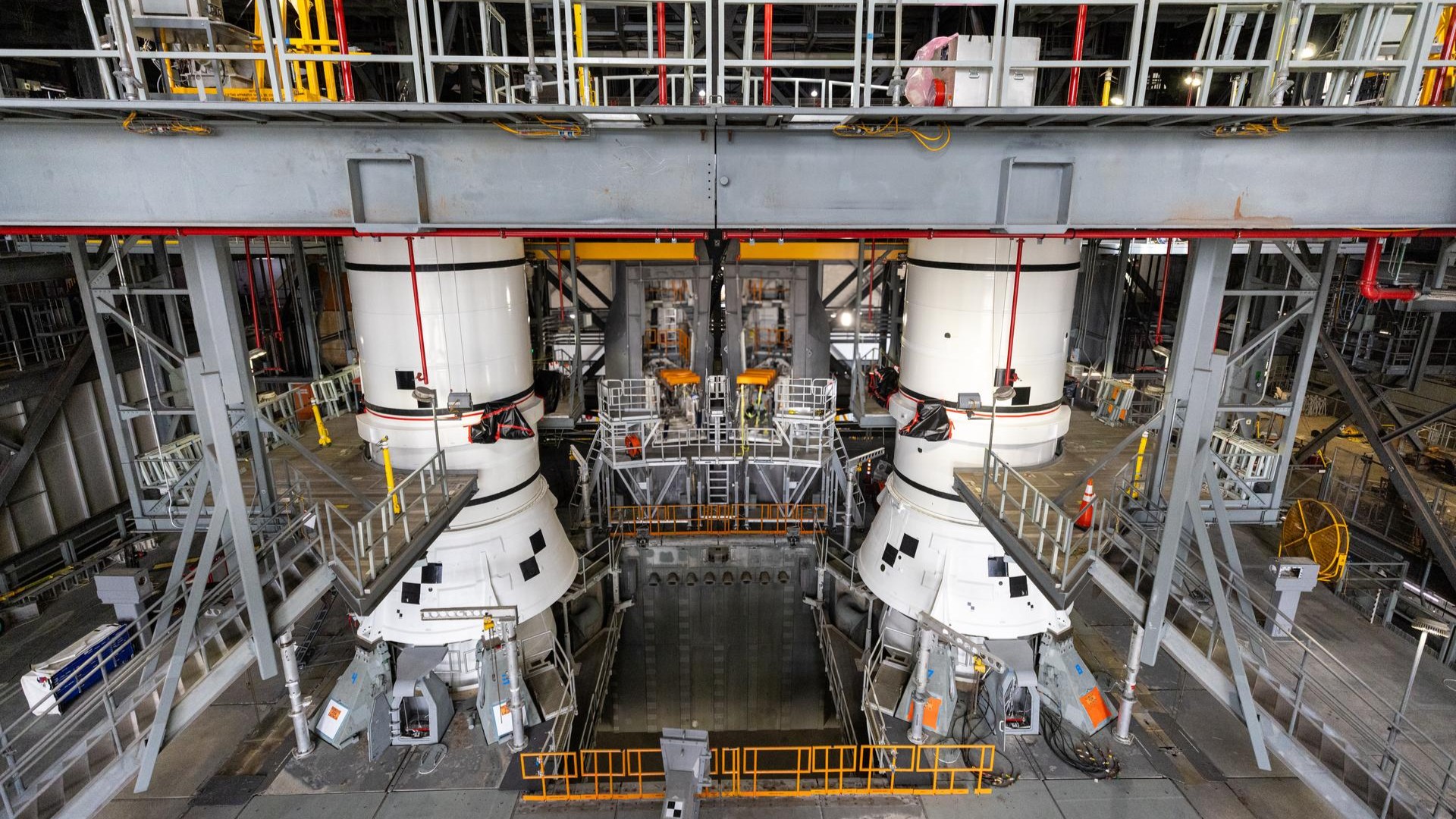 The left-hand and right-hand aft assembly solid rocket booster segments for NASA’s Artemis III SLS (Space Launch System) rocket are secured to the mobile launcher at the agency’s Vehicle Assembly Building at NASA’s Kennedy Space Center in Florida on July 11, 2026. 
