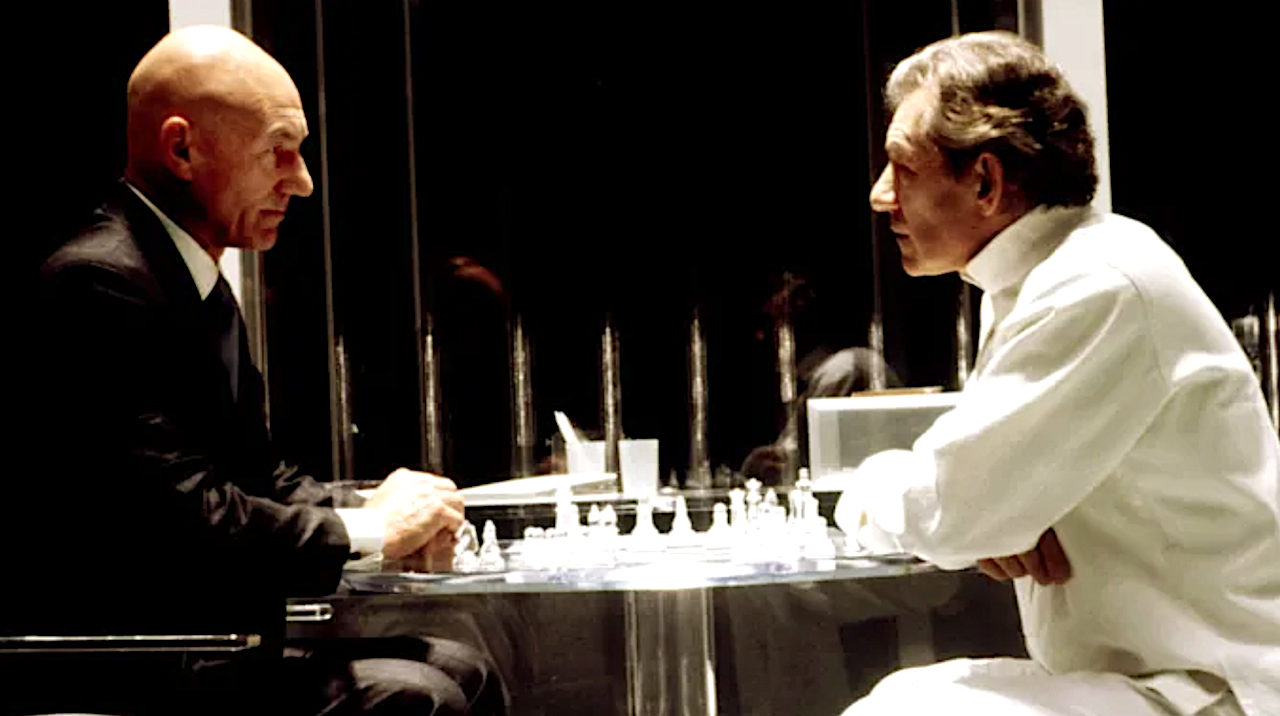 two men playing a game of chess in a glass room
