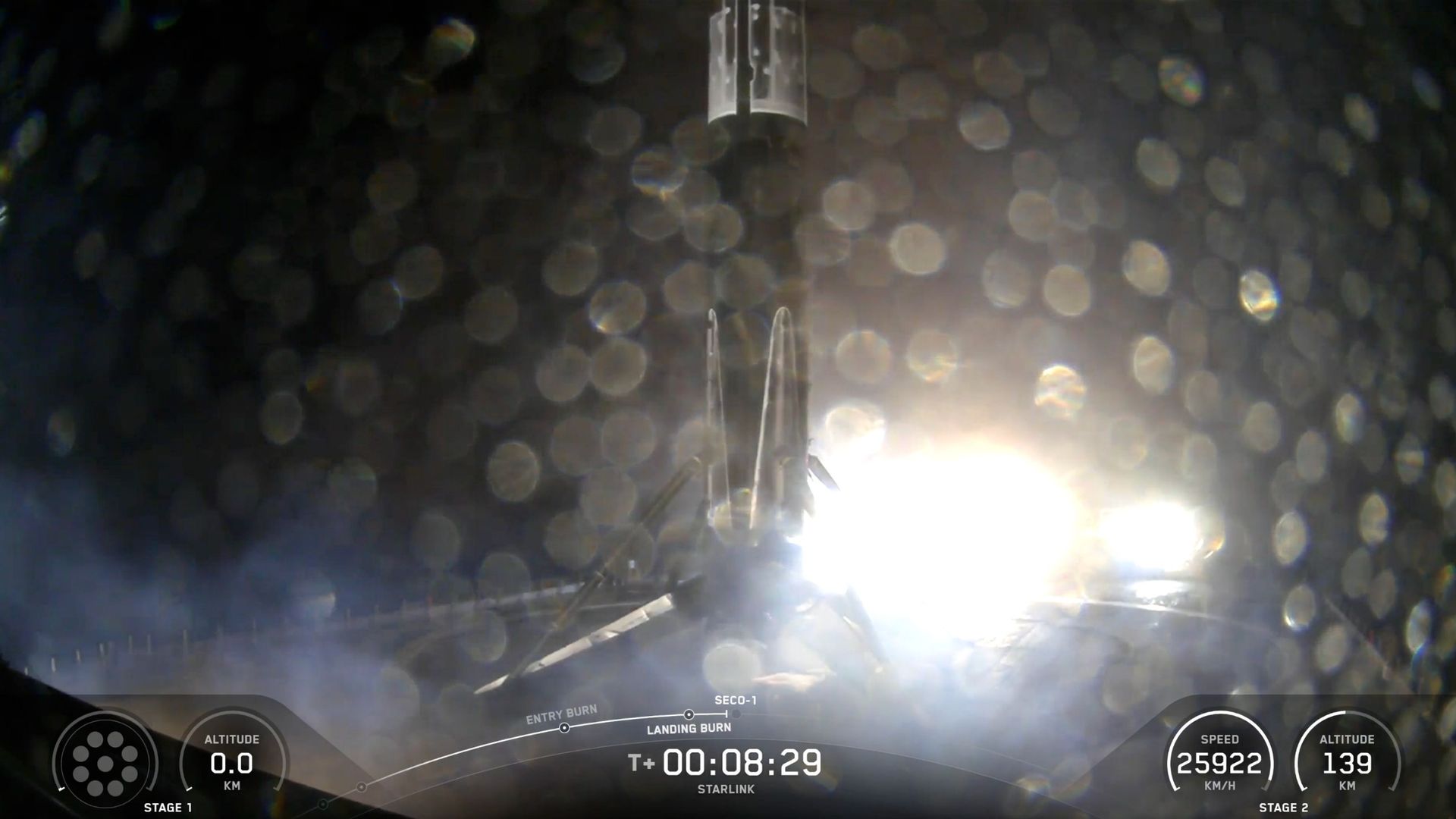 a black and white rocket sits on the deck of a ship at sea at night