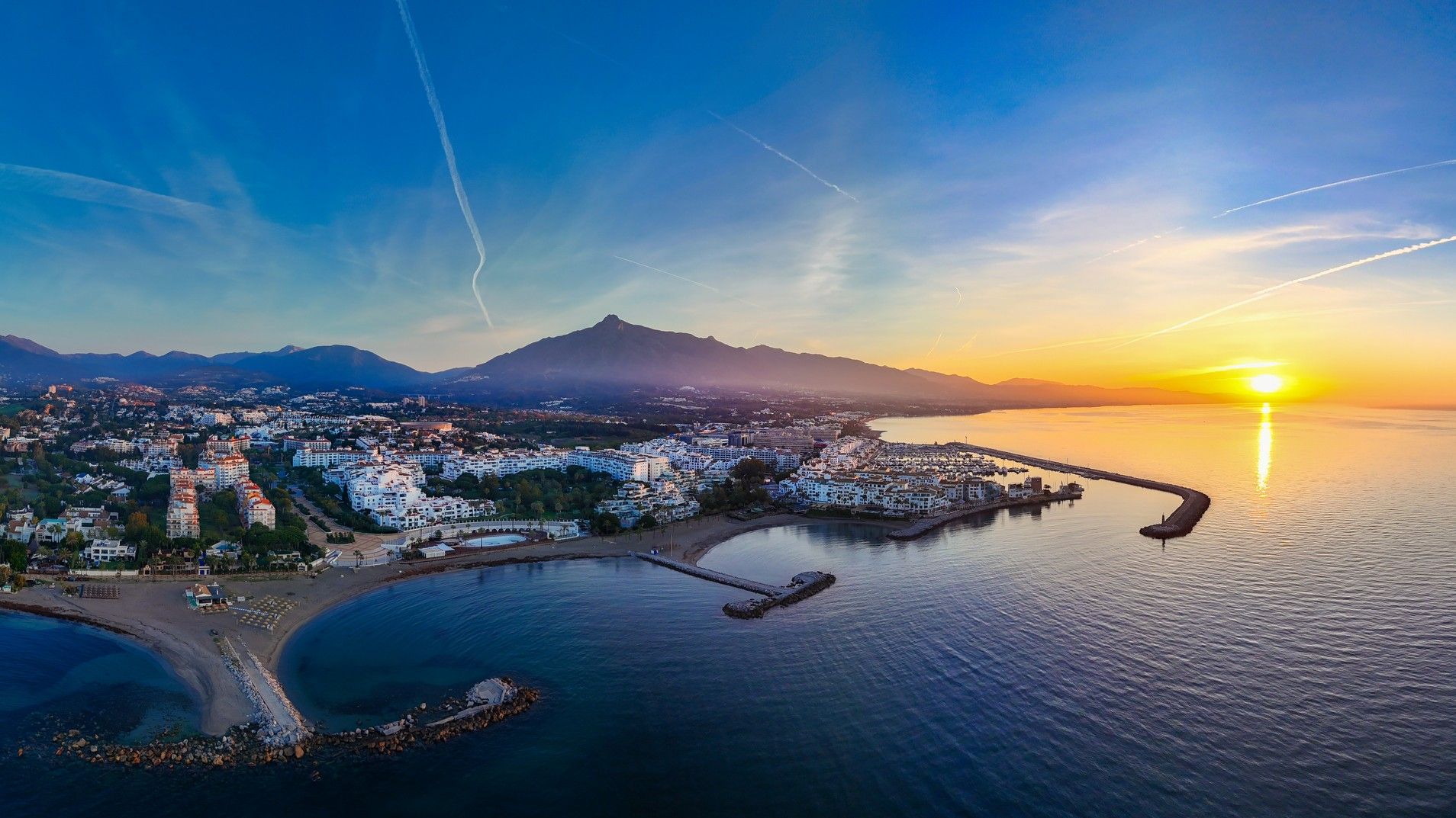 Aerial view of a large marina at sunrise.