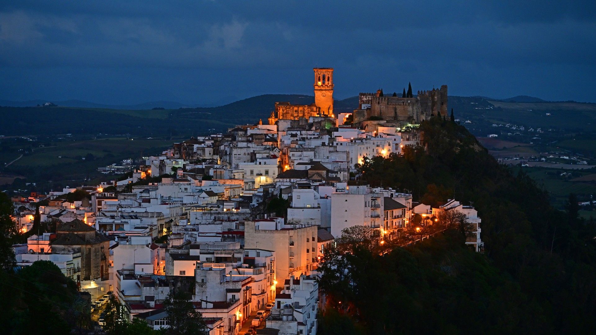 High angle view of illuminated buildings in a city at night.