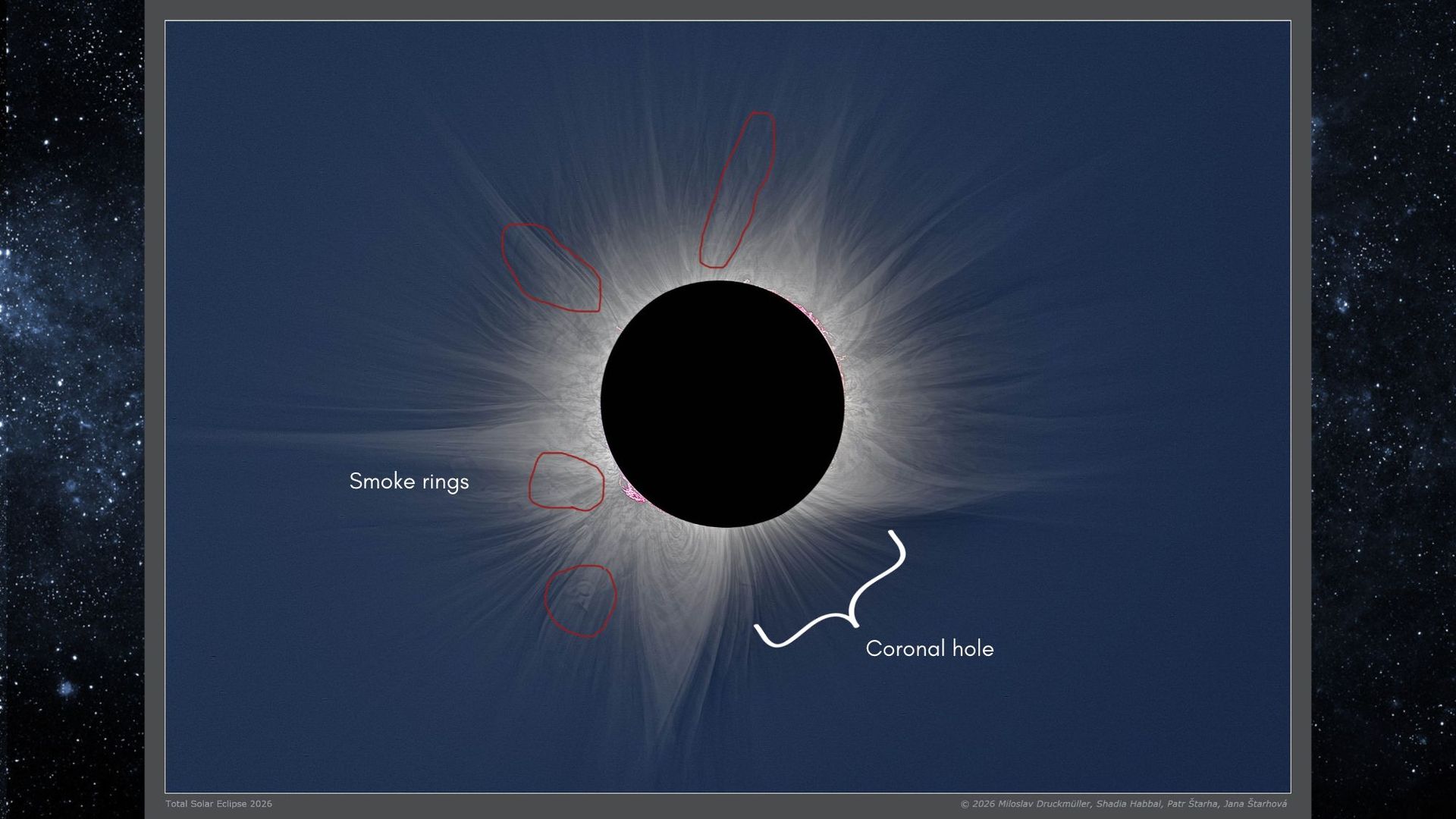 close up view of a total solar eclipse showing large white streamers streaking out from the sun, this is the sun's corona.